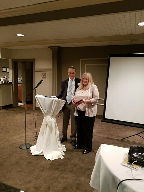 Dr. Worth presents Irene Kapsaskis with a gift of appreciation from the Society